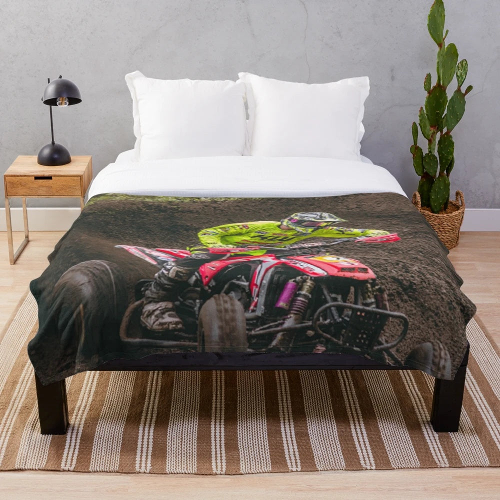 Plush blanket featuring an ATV quad racing through the mud
