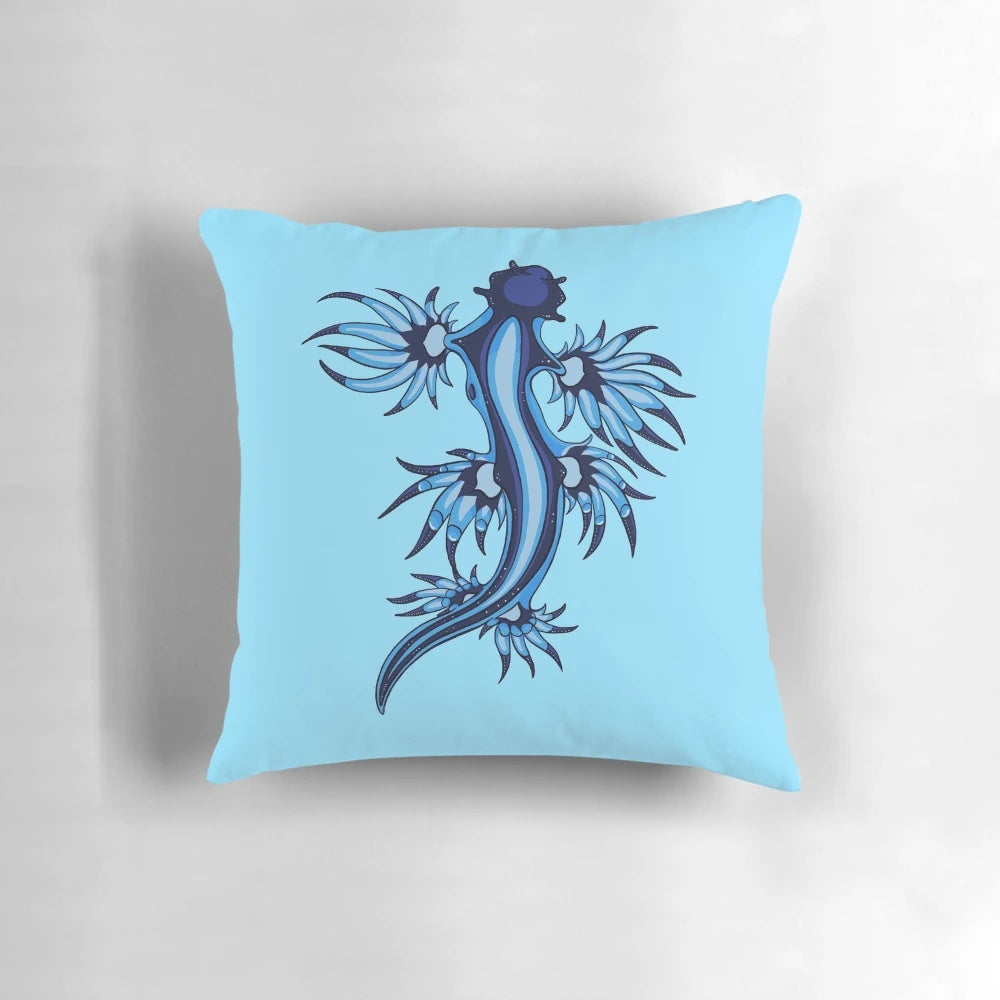 Vibrant blue and white pillow featuring the stunning Glaucus Atlanticus nudibranch, a fascinating marine invertebrate species.