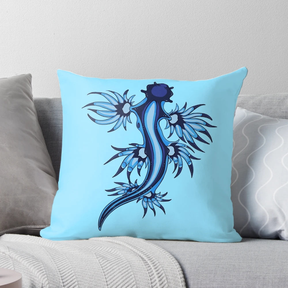 Vibrant blue and white pillow featuring the stunning Glaucus Atlanticus nudibranch, a fascinating marine invertebrate species.