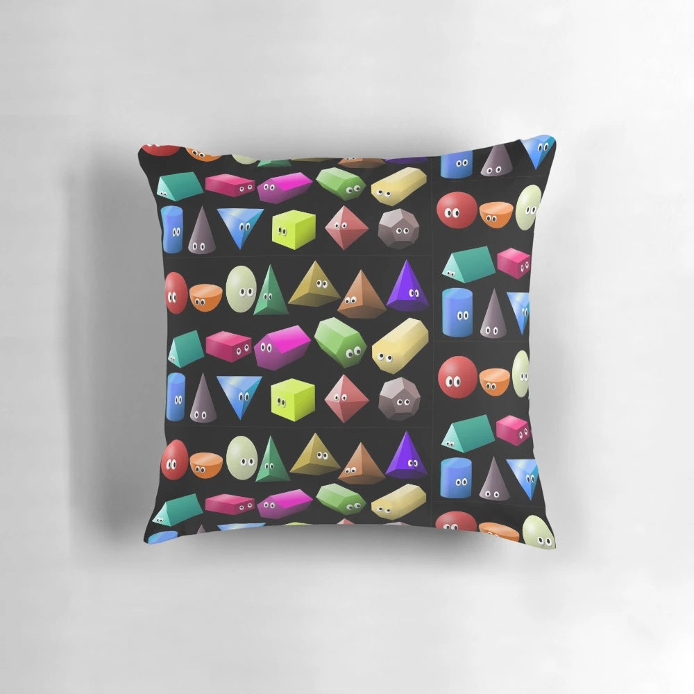 A colorful 3D shapes pillow featuring spheres and cubes, designed to teach children about geometry.