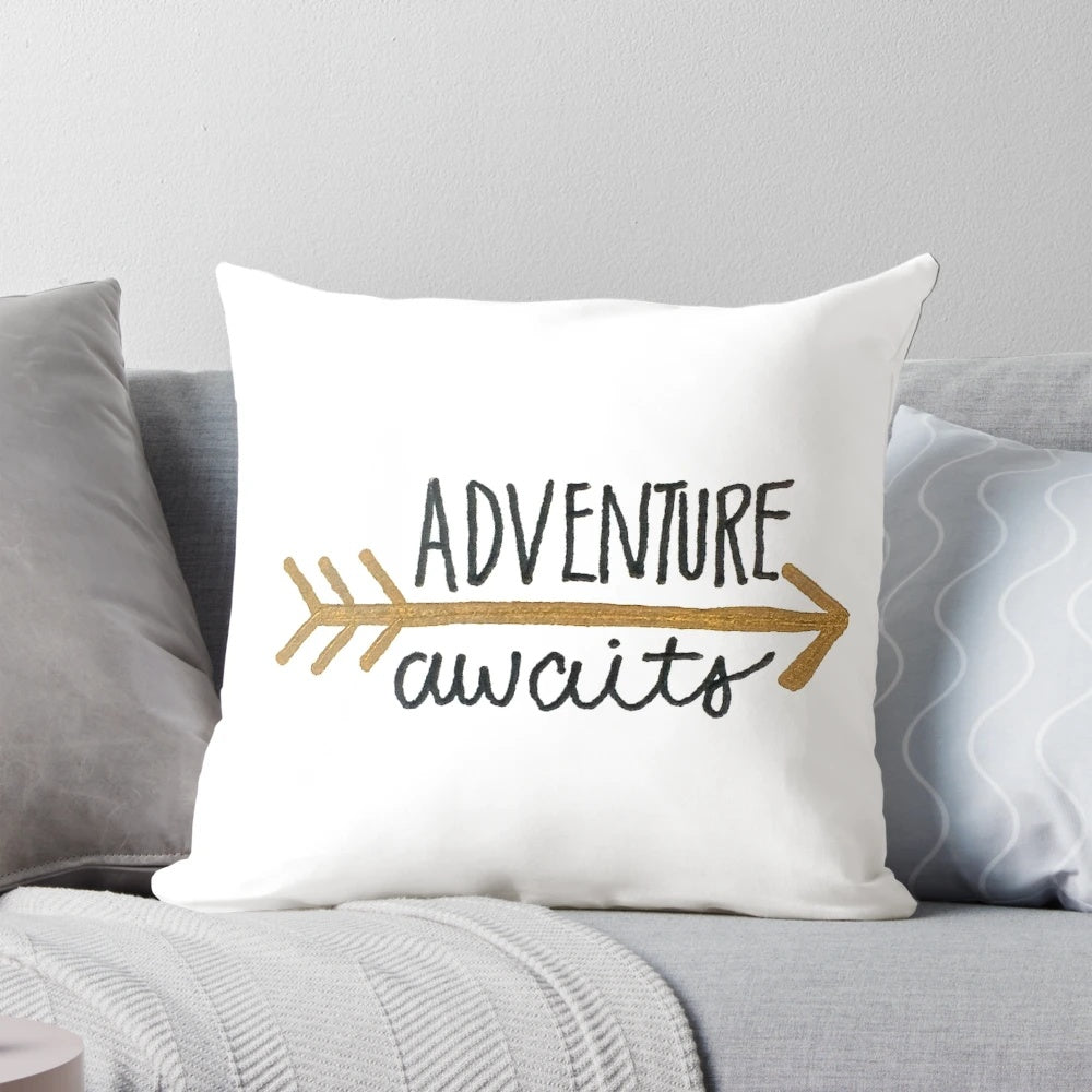 Black and gold hand lettered "Adventure Awaits" pillow