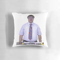 A plush pillow featuring a smiling man wearing goggles, representing the University of Wisconsin's chemistry lab.