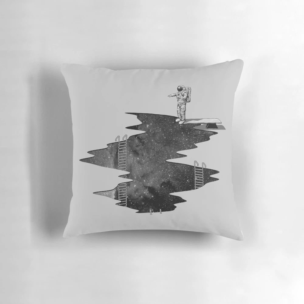 A plush pillow featuring an astronaut diving through the stars and galaxies of outer space.
