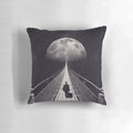 A surreal, space-themed pillow with stars, a moon, and a lone astronaut floating in the galaxy.
