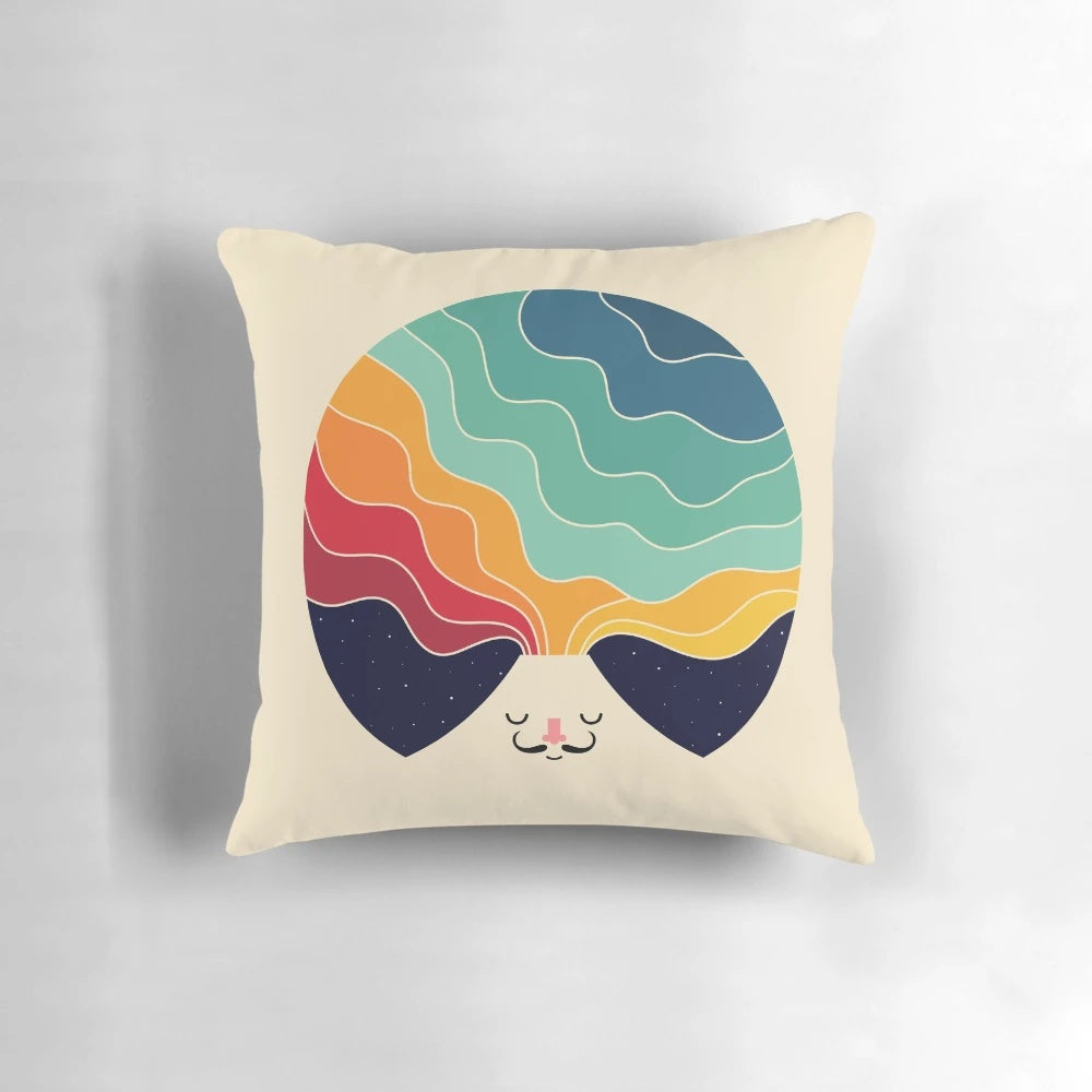 A colorful pillow featuring a magical landscape with mountains, galaxies, and stars