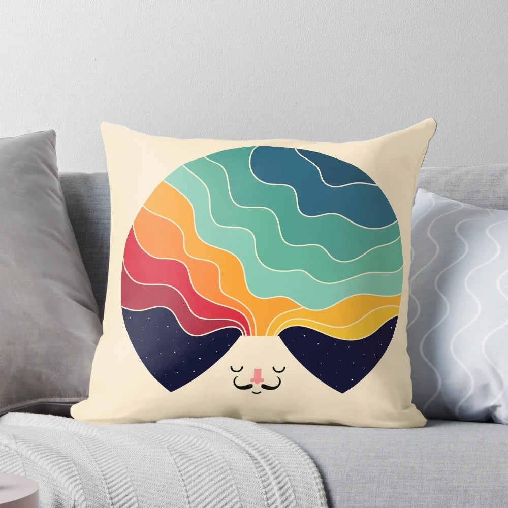 A colorful pillow featuring a magical landscape with mountains, galaxies, and stars
