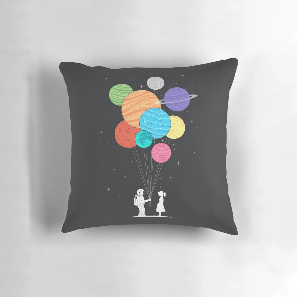 A plush, space-themed pillow featuring a starry night sky, planets, and a heart-shaped design