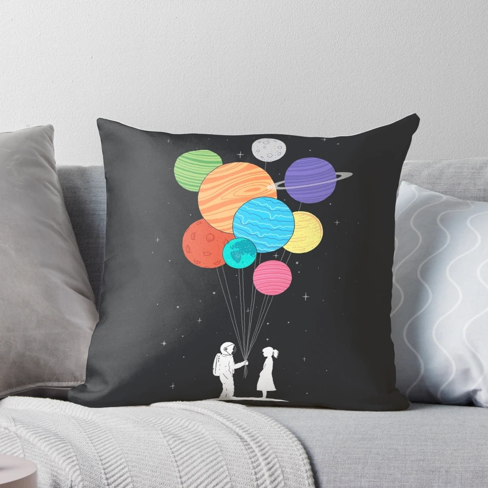 A plush, space-themed pillow featuring a starry night sky, planets, and a heart-shaped design