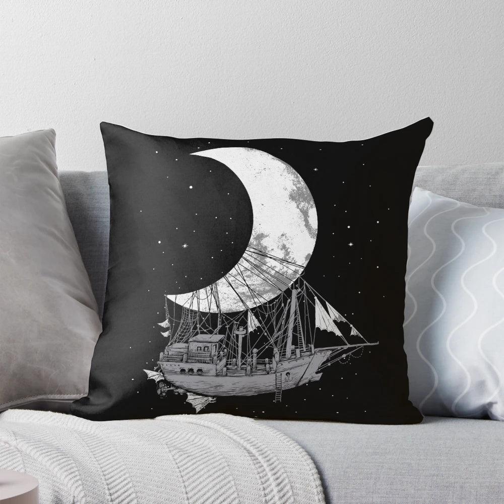 A stylish black and white pillow featuring a crescent moon and space ship design, perfect for adding a touch of adventure and fantasy to any room.