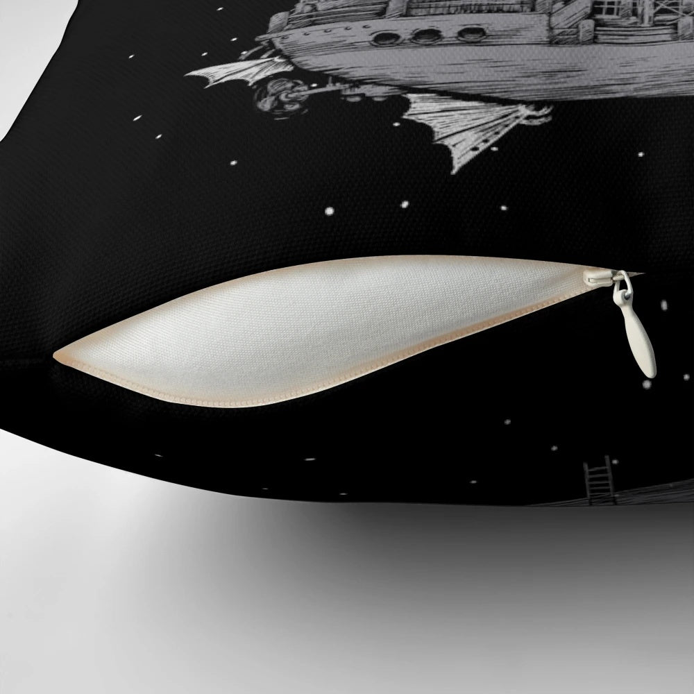 A stylish black and white pillow featuring a crescent moon and space ship design, perfect for adding a touch of adventure and fantasy to any room.