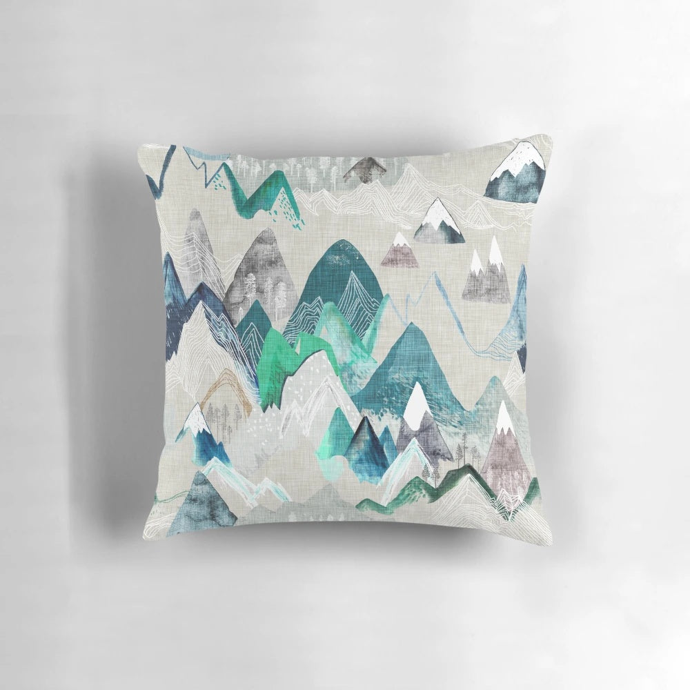 A watercolor-style illustration of a scenic mountain landscape with trees, adorning a soft and plush pillow.