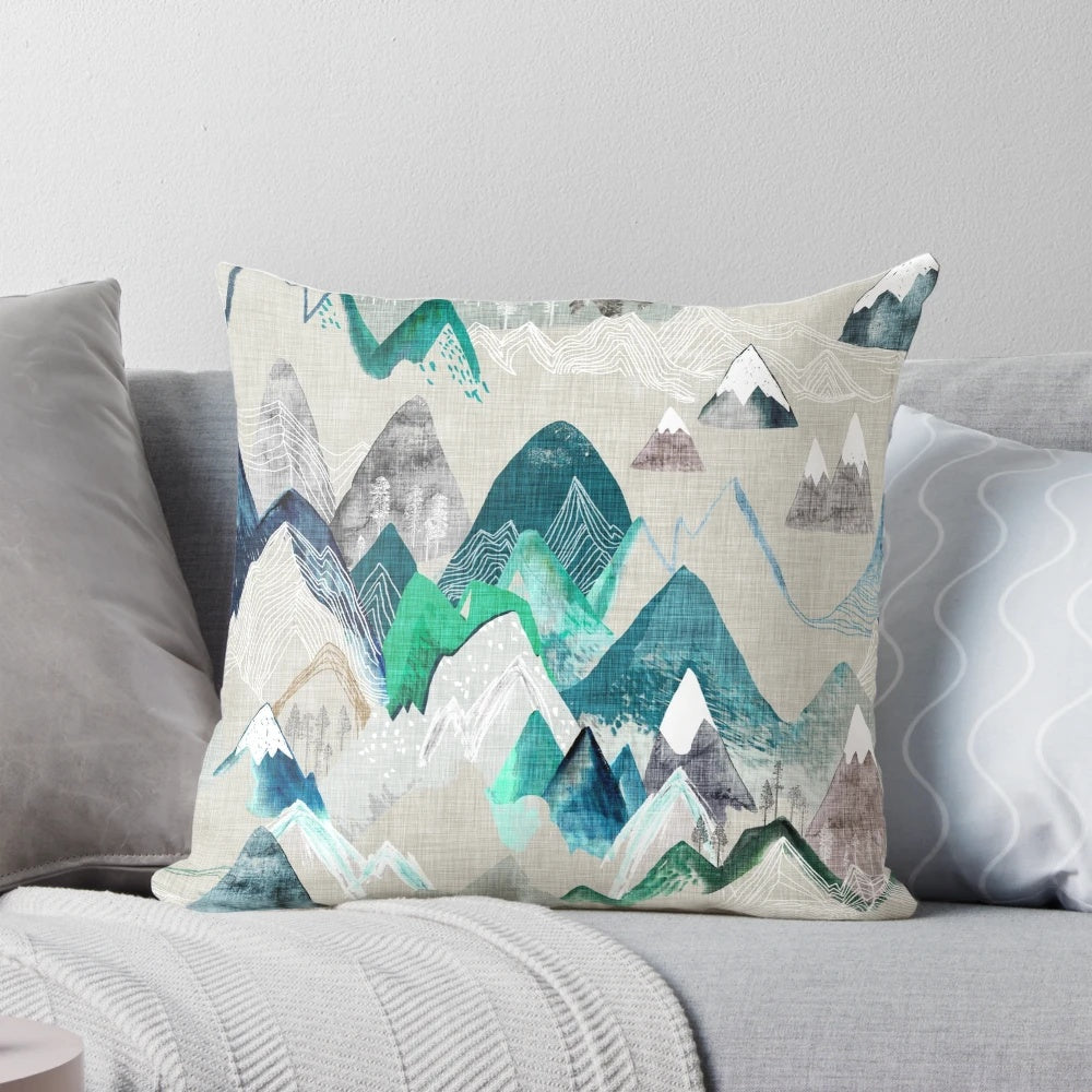 A watercolor-style illustration of a scenic mountain landscape with trees, adorning a soft and plush pillow.