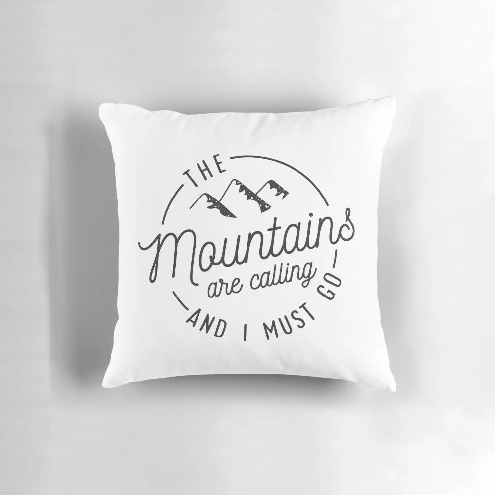 A vintage-style pillow featuring a mountain range and the text "The Mountains Are Calling And I Must Go
