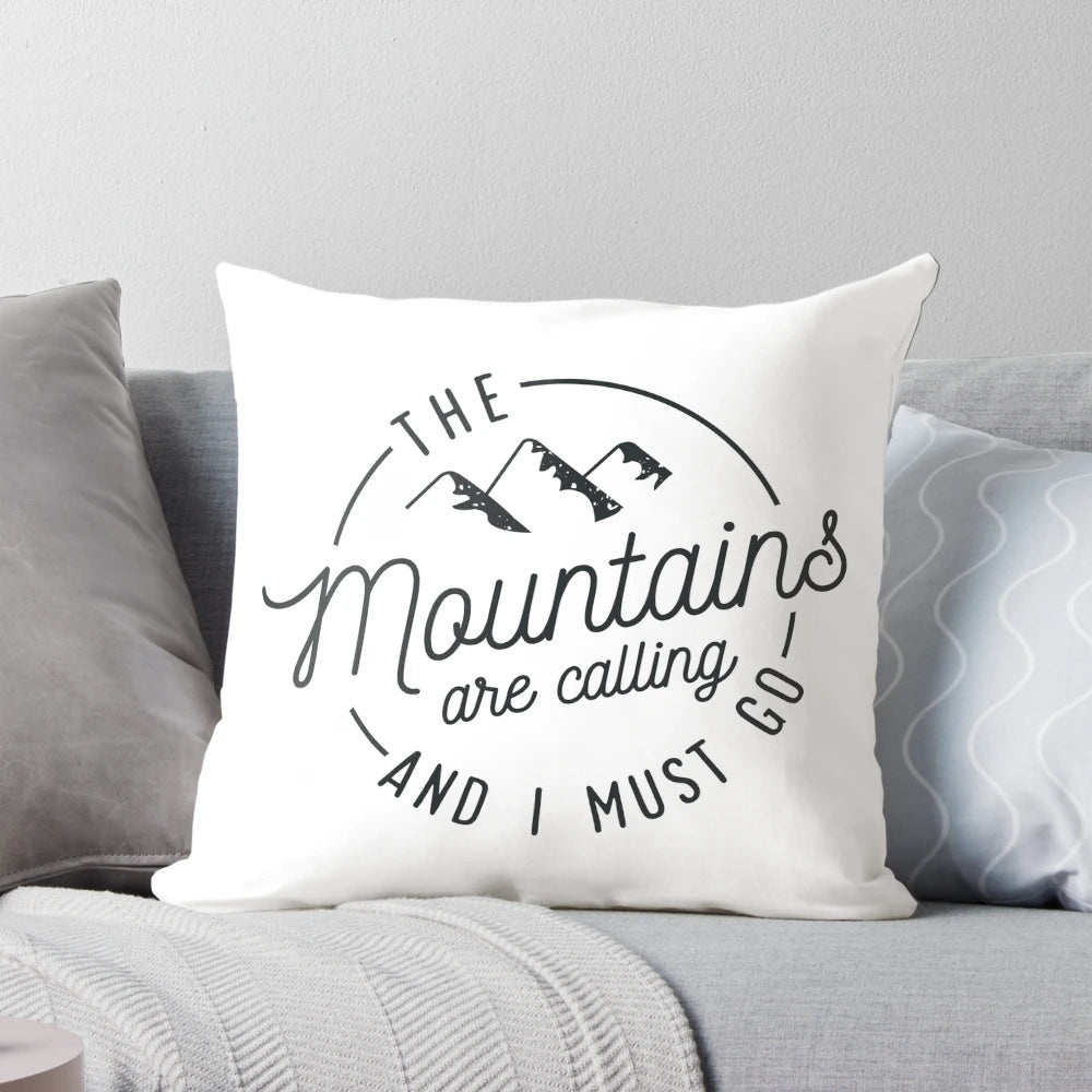 A vintage-style pillow featuring a mountain range and the text "The Mountains Are Calling And I Must Go