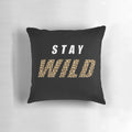 Stylish pillow featuring the quote "Stay Wild" and a design inspired by nature and adventure, featuring the name "Ben Azelart".