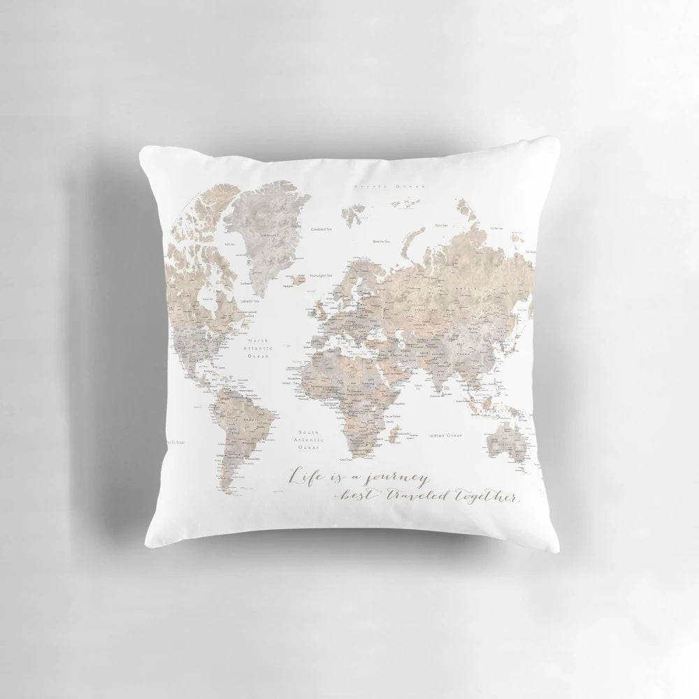 Neutral-colored "Abey" pillow featuring a detailed watercolor world map design, perfect for couples and home decor.
