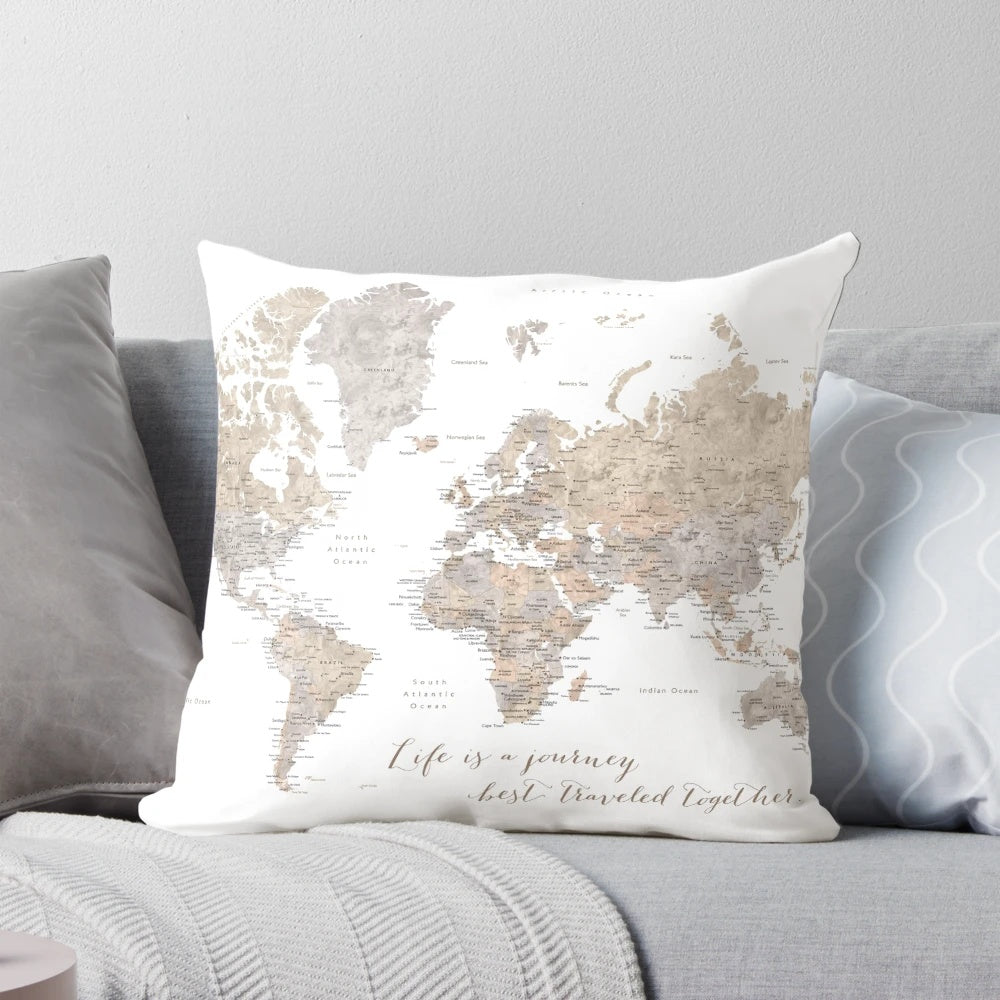Neutral-colored "Abey" pillow featuring a detailed watercolor world map design, perfect for couples and home decor.
