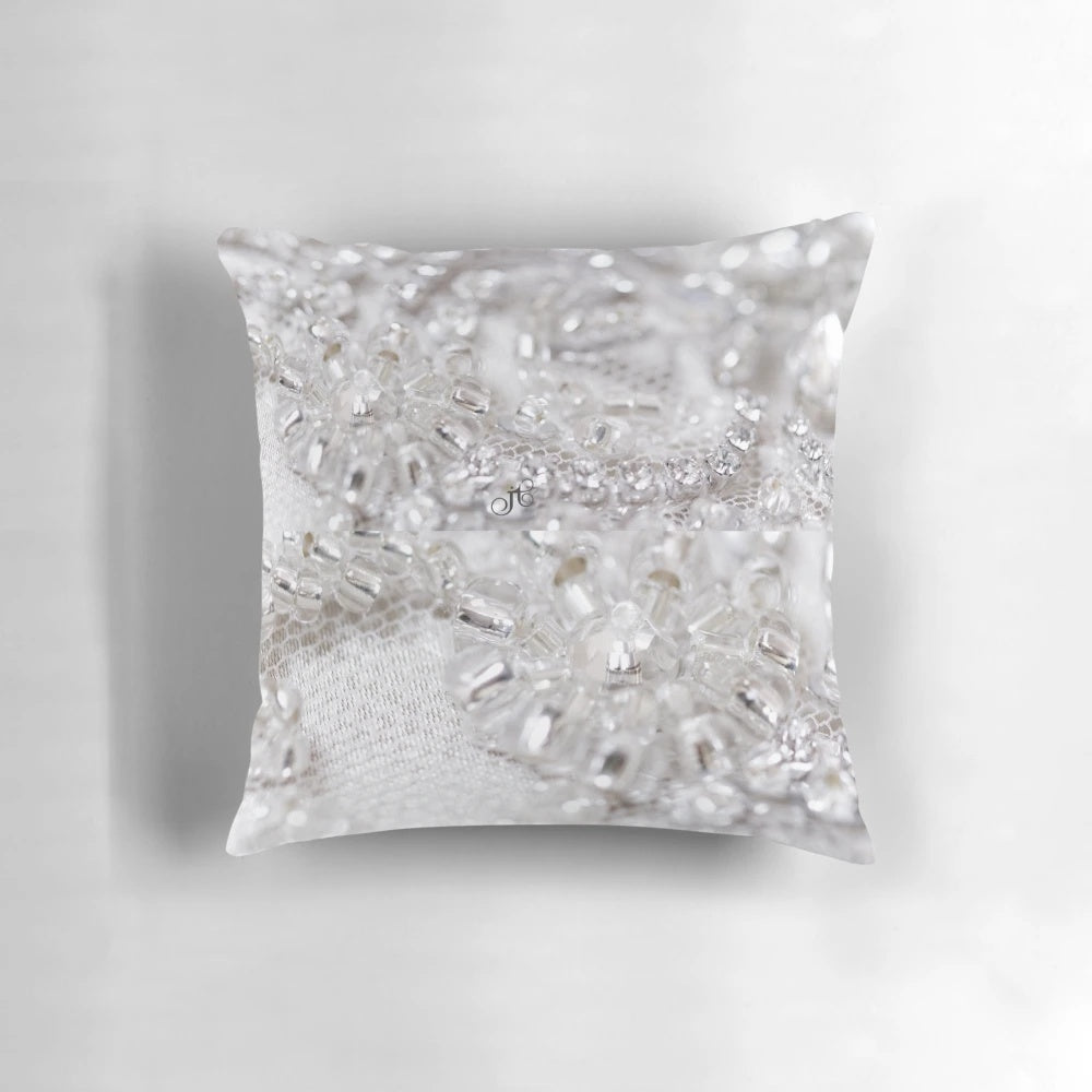 Closeup of a beautifully crafted beaded decorative pillow with lace, tulle, and confetti accents