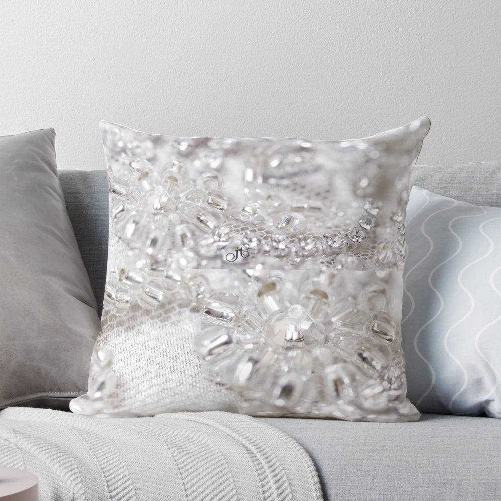 Closeup of a beautifully crafted beaded decorative pillow with lace, tulle, and confetti accents