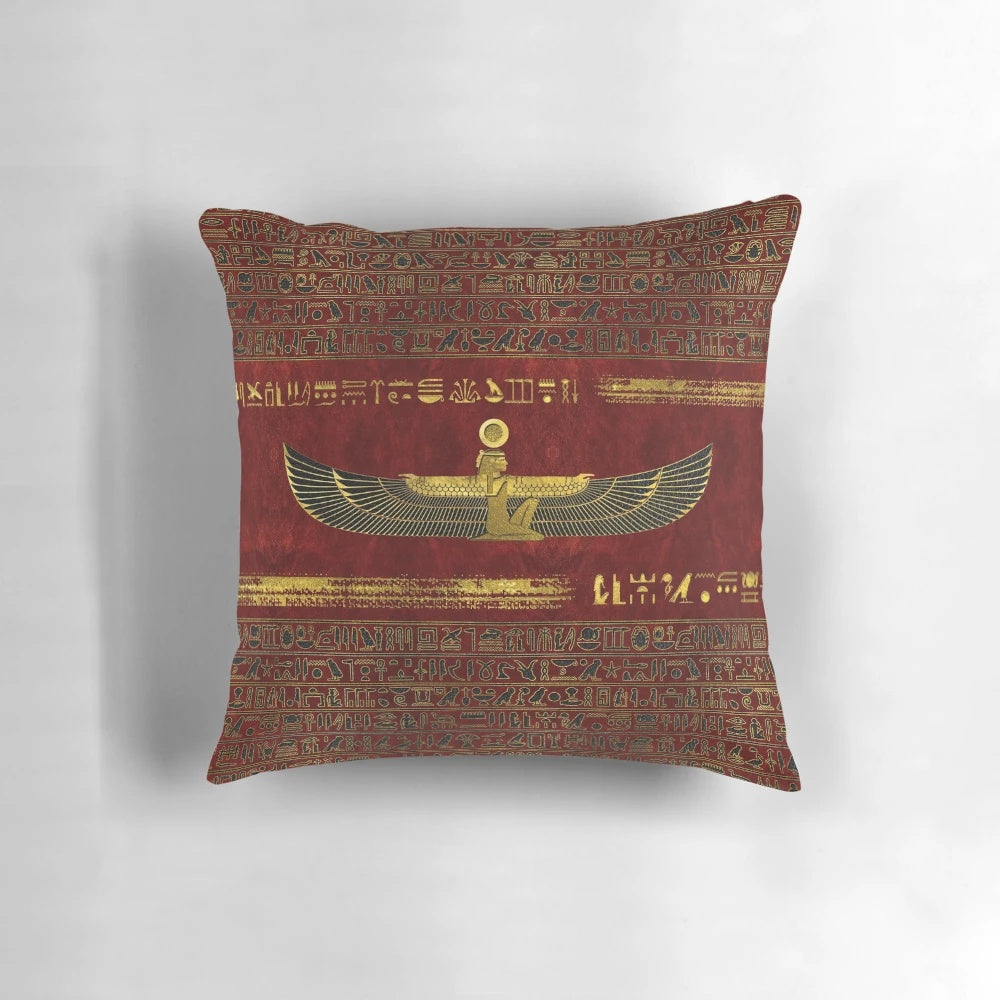 Golden Egyptian god ornament on a rich, red leather pillow