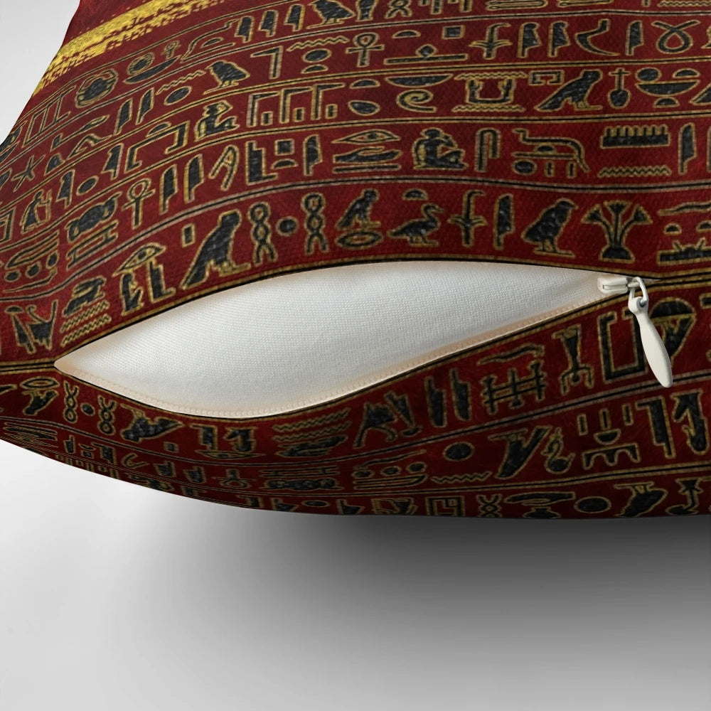 Golden Egyptian god ornament on a rich, red leather pillow