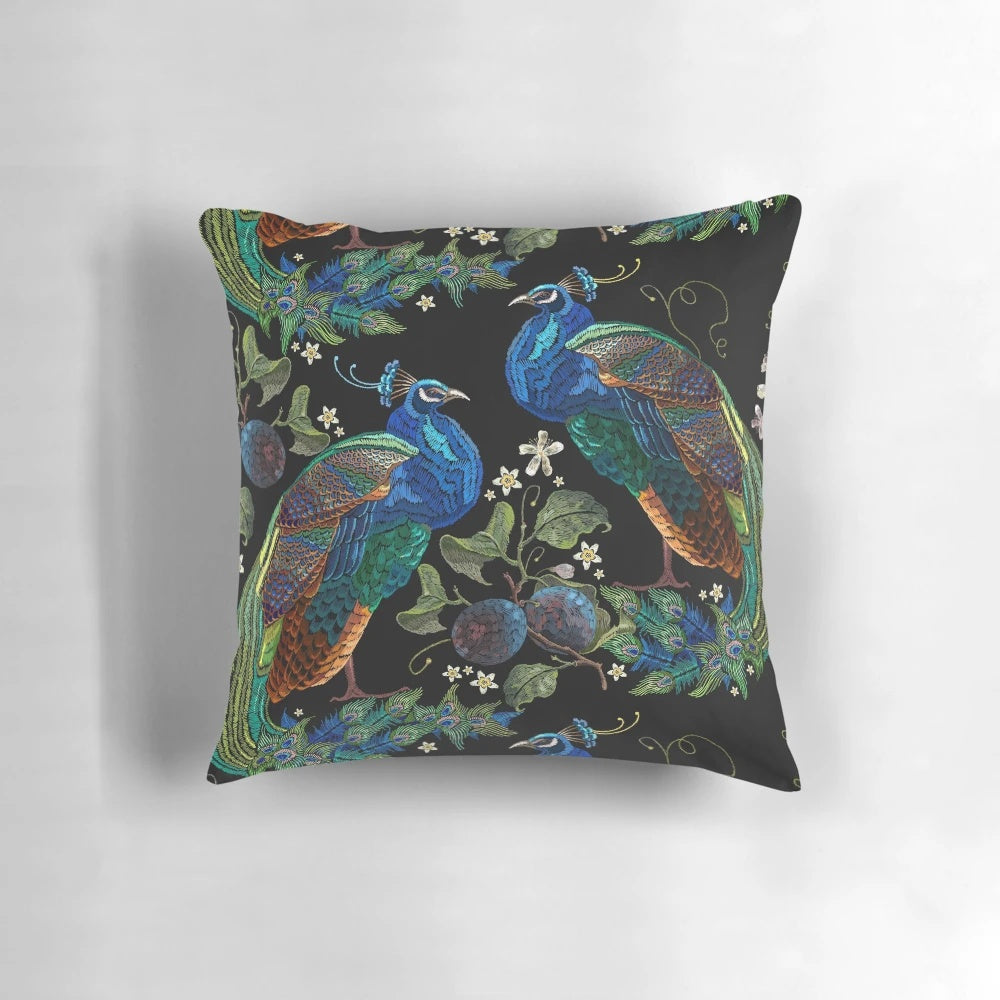 Closeup of an embroidered peacock design on a plush decorative pillow