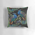 Closeup of an embroidered peacock design on a plush decorative pillow