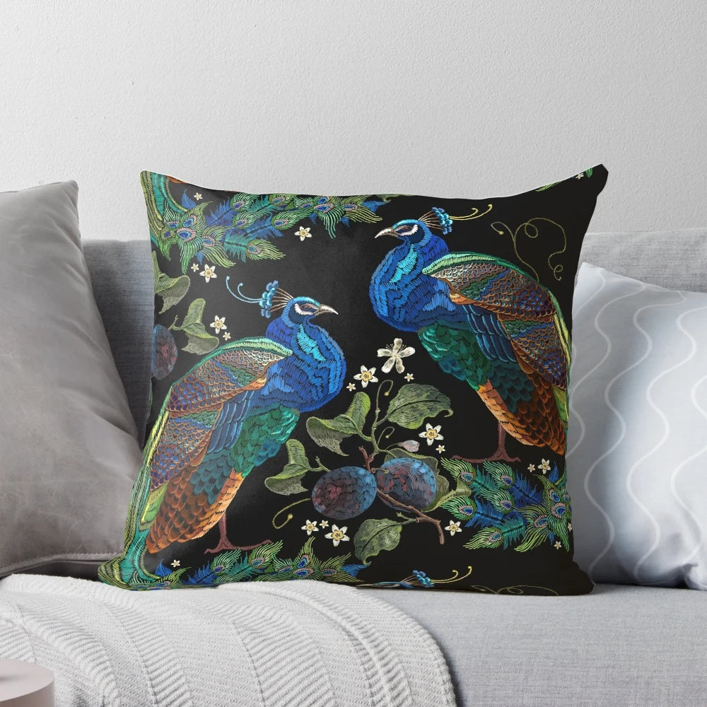 Closeup of an embroidered peacock design on a plush decorative pillow