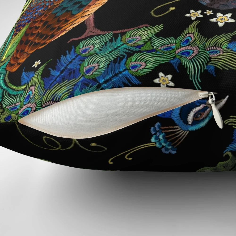 Closeup of an embroidered peacock design on a plush decorative pillow