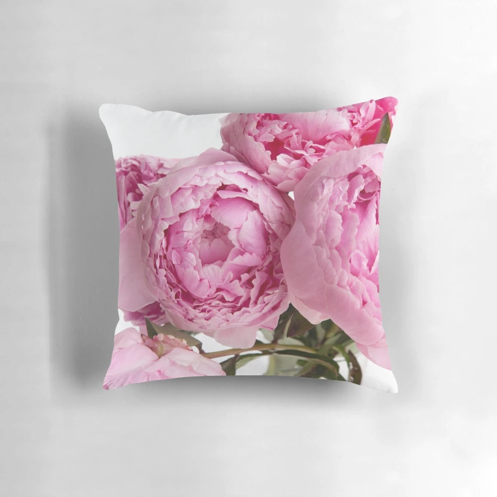 Beautifully arranged pink peonies on a decorative pillow for home decor