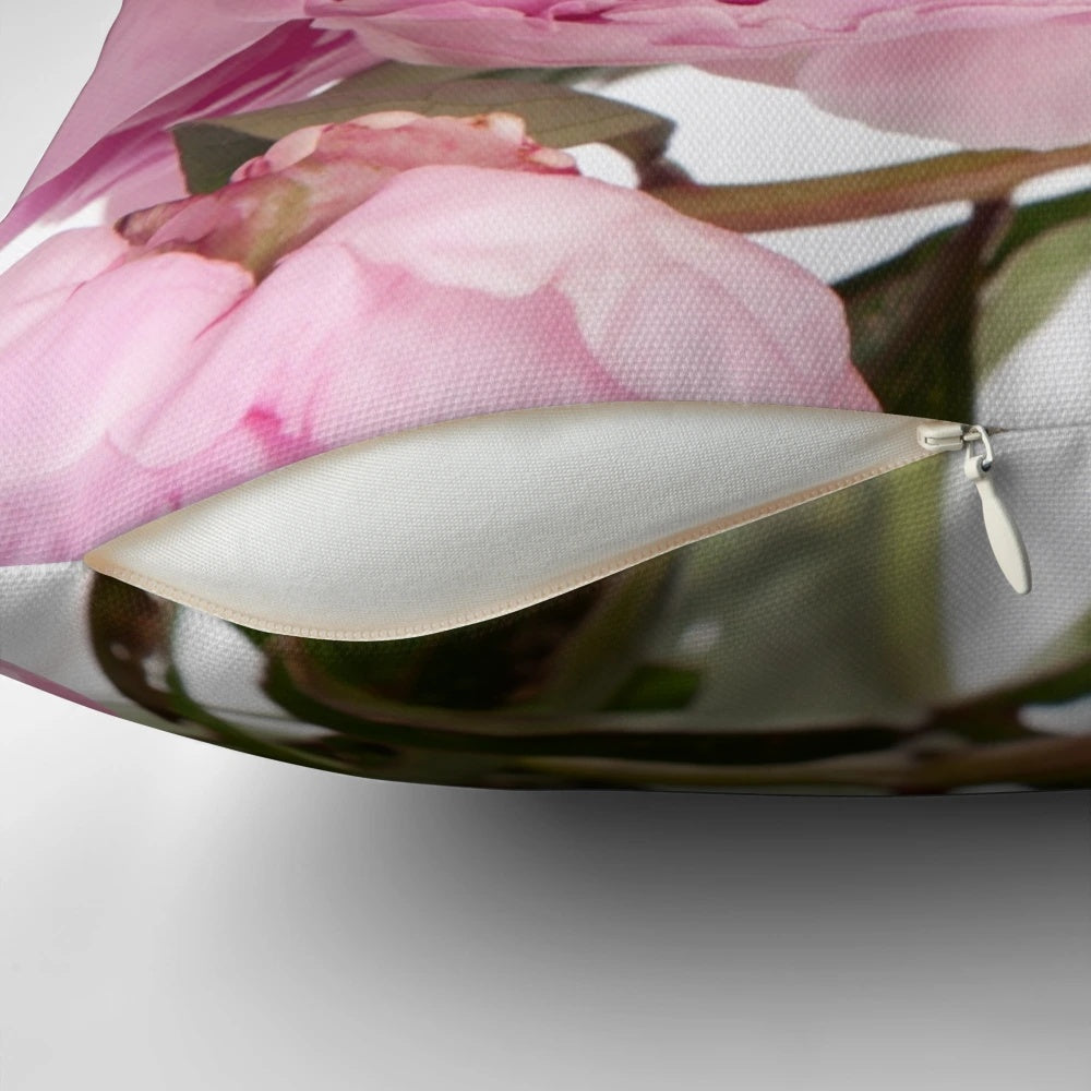 Beautifully arranged pink peonies on a decorative pillow for home decor