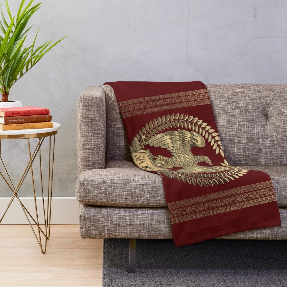 Plush blanket featuring the Roman Empire's iconic gold imperial eagle emblem on a rich red velvet backdrop