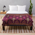 Thai silk plush blanket with pink gold tones and traditional silkworm design