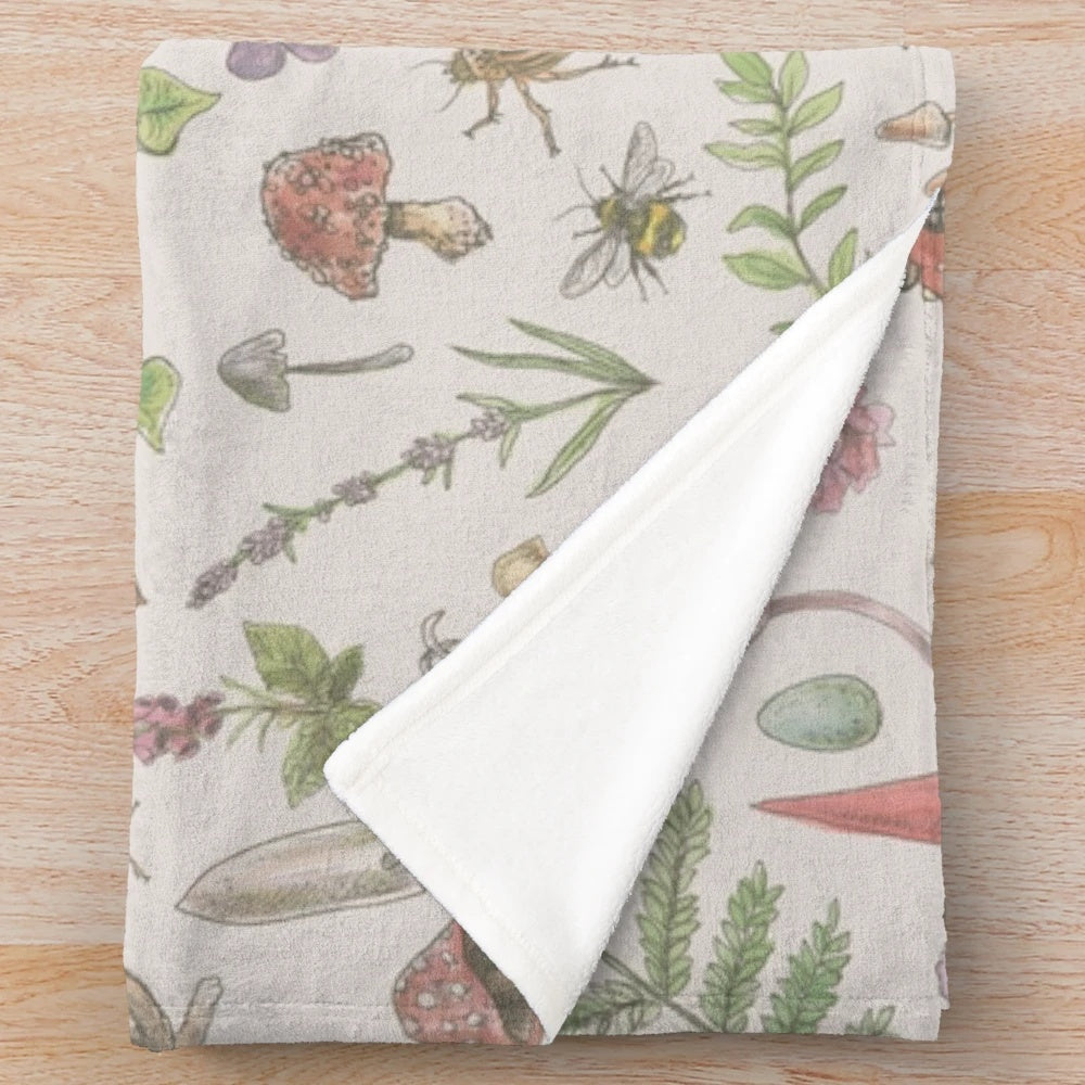 Faded pink plush blanket with floral and botanical design