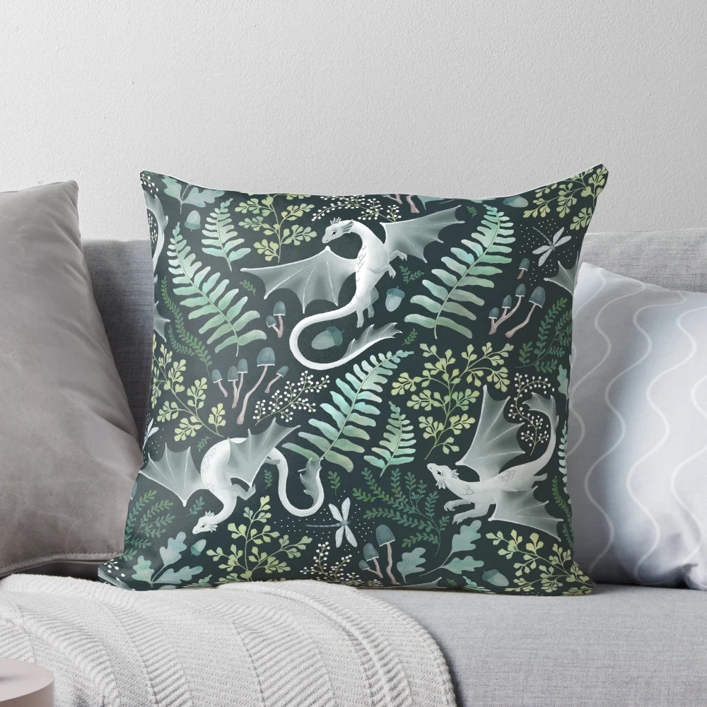 A decorative throw pillow featuring a whimsical forest dragon design in shades of green on a dark green background, perfect for nature-inspired home decor.