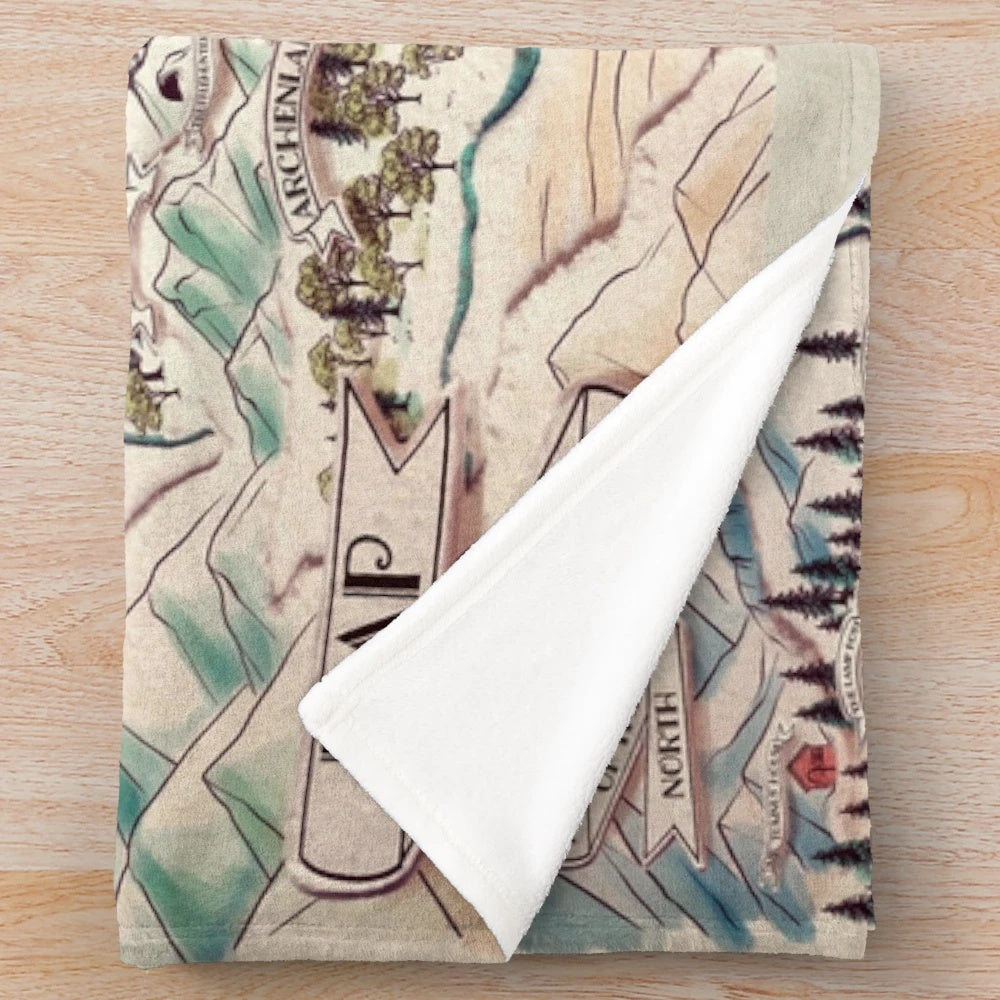 Narnia-inspired plush blanket with a map of the fantasy world