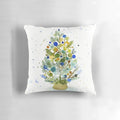 Farmhouse-style watercolor painting of a Christmas tree in blue, green, and earth tones on a cozy throw pillow.