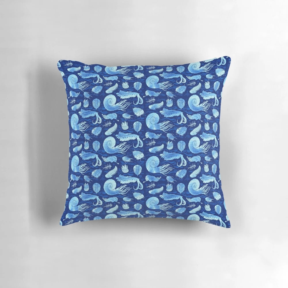 Pillow featuring illustrations of trilobites, anomalocaris, wiwaxia, and other ancient marine creatures on a dark background.