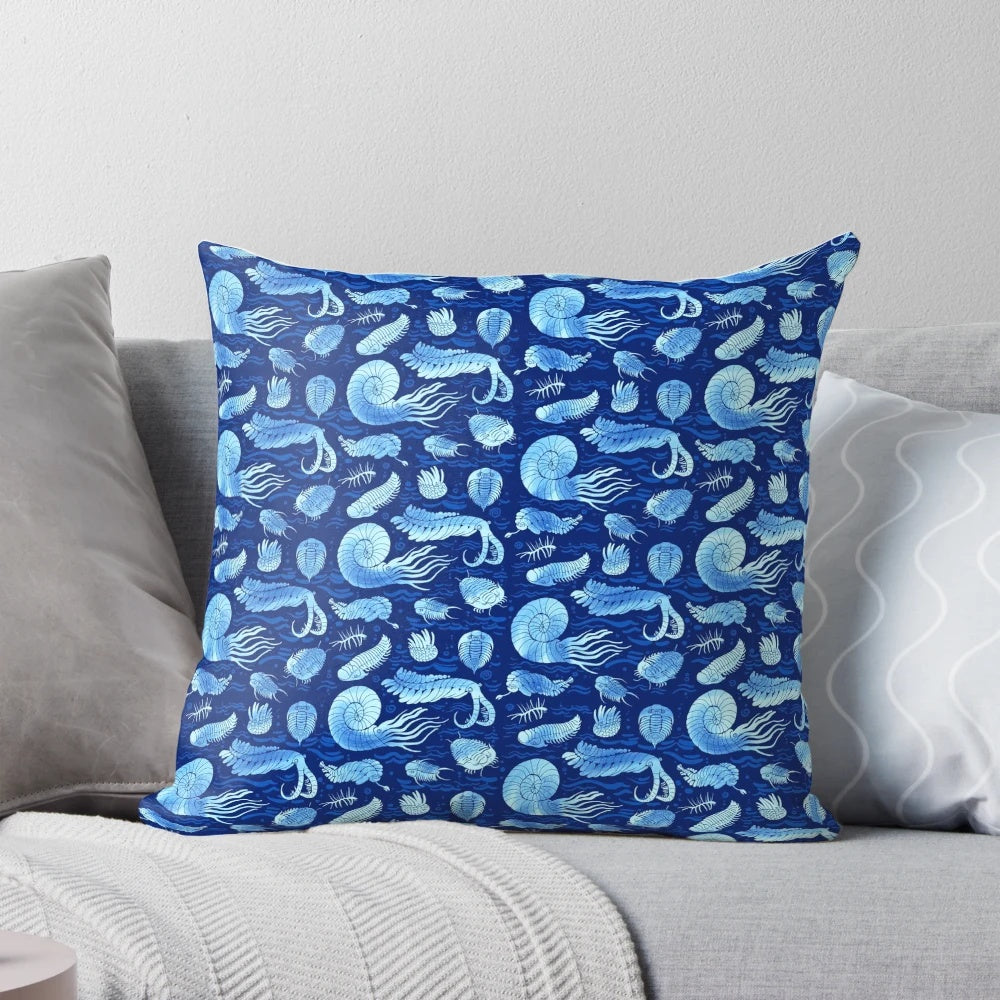 Pillow featuring illustrations of trilobites, anomalocaris, wiwaxia, and other ancient marine creatures on a dark background.