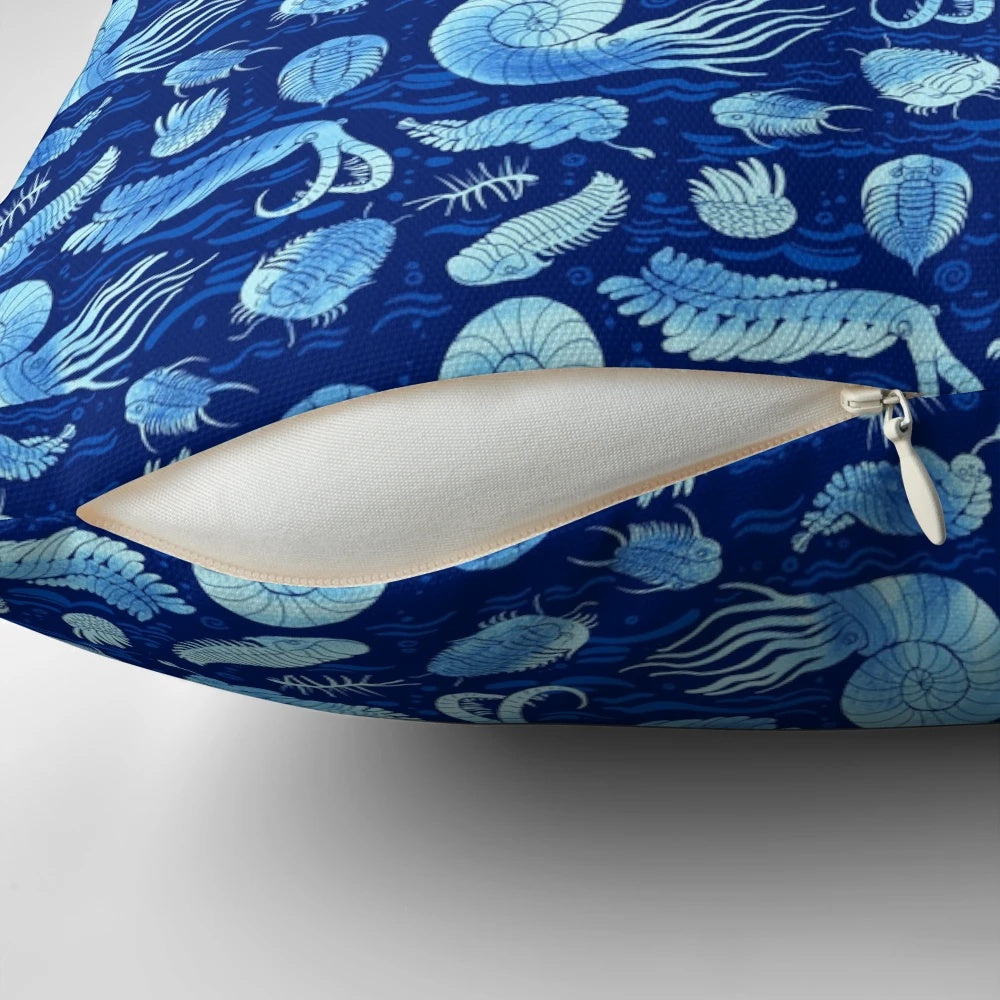Pillow featuring illustrations of trilobites, anomalocaris, wiwaxia, and other ancient marine creatures on a dark background.