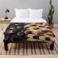 Copper and black plush blanket with abstract feathered pattern