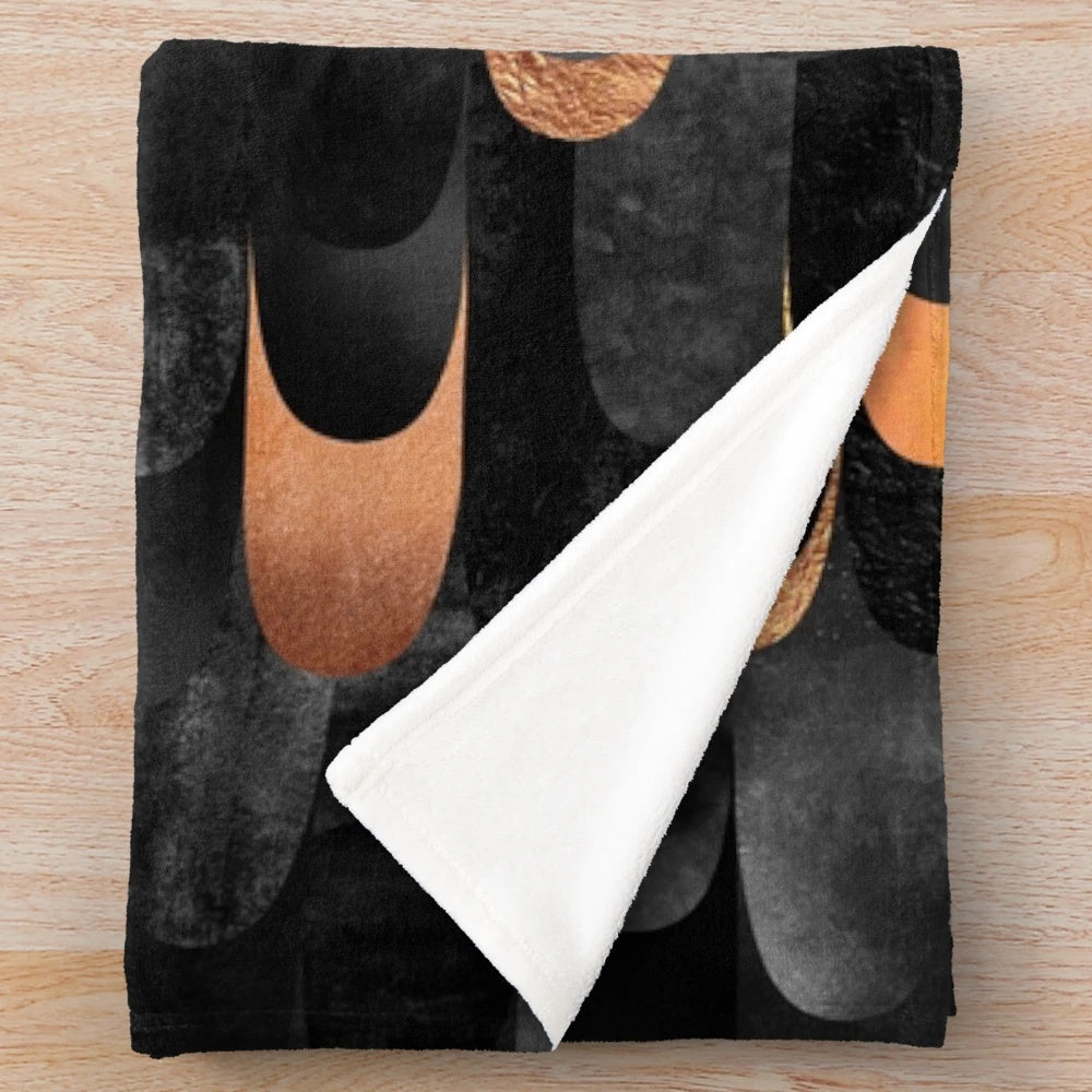 Copper and black plush blanket with abstract feathered pattern