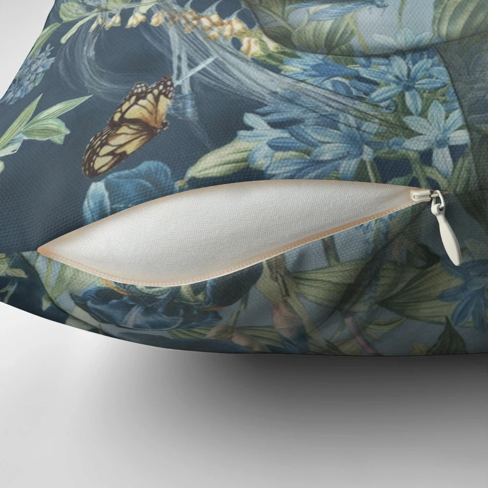Decorative floral pillow featuring a feminine portrait of women surrounded by botanicals, birds, and flowers in pink and blue hues.