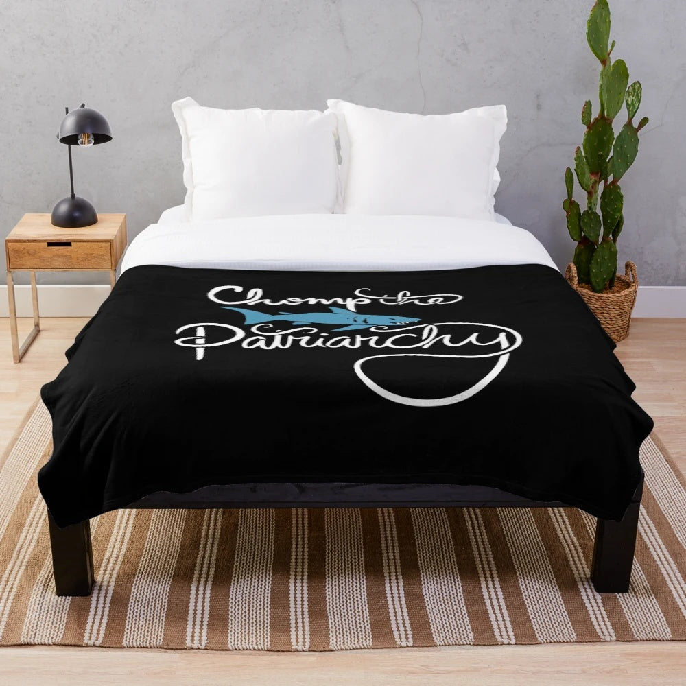 Feminist shark plush blanket with "Chomp the Patriarchy" design