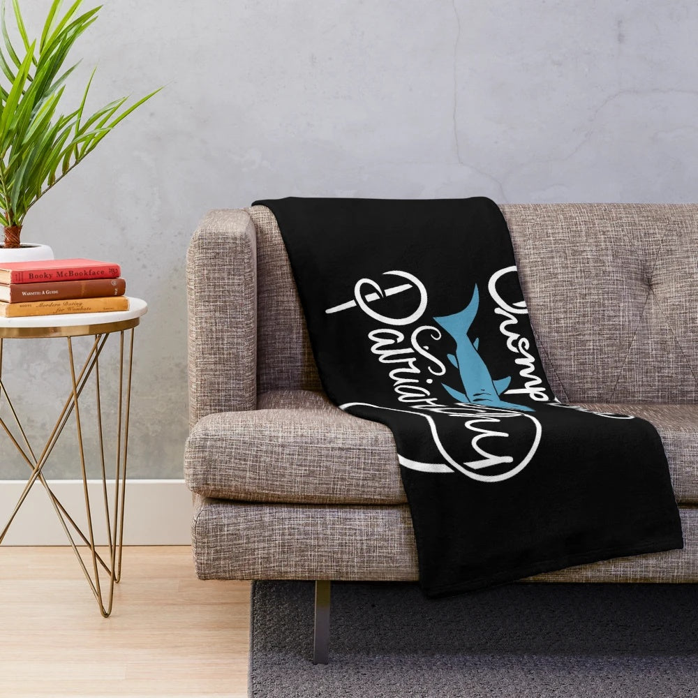 Feminist shark plush blanket with "Chomp the Patriarchy" design