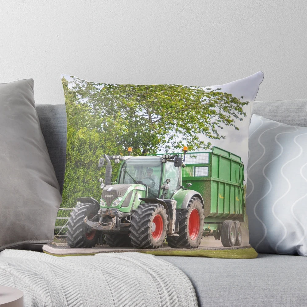 Fendt tractor pulling a silage trailer in a lush green countryside field