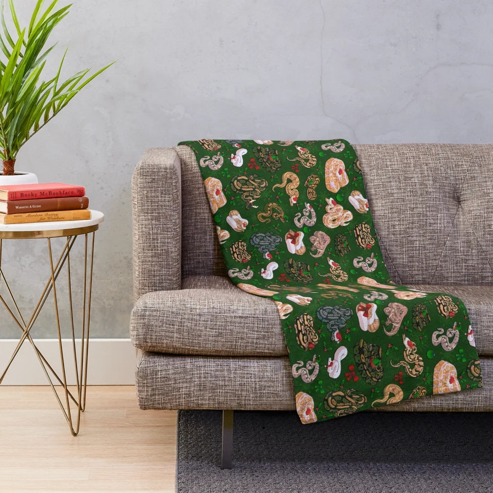 Cozy and soft plush blanket featuring a ball python in a holiday design