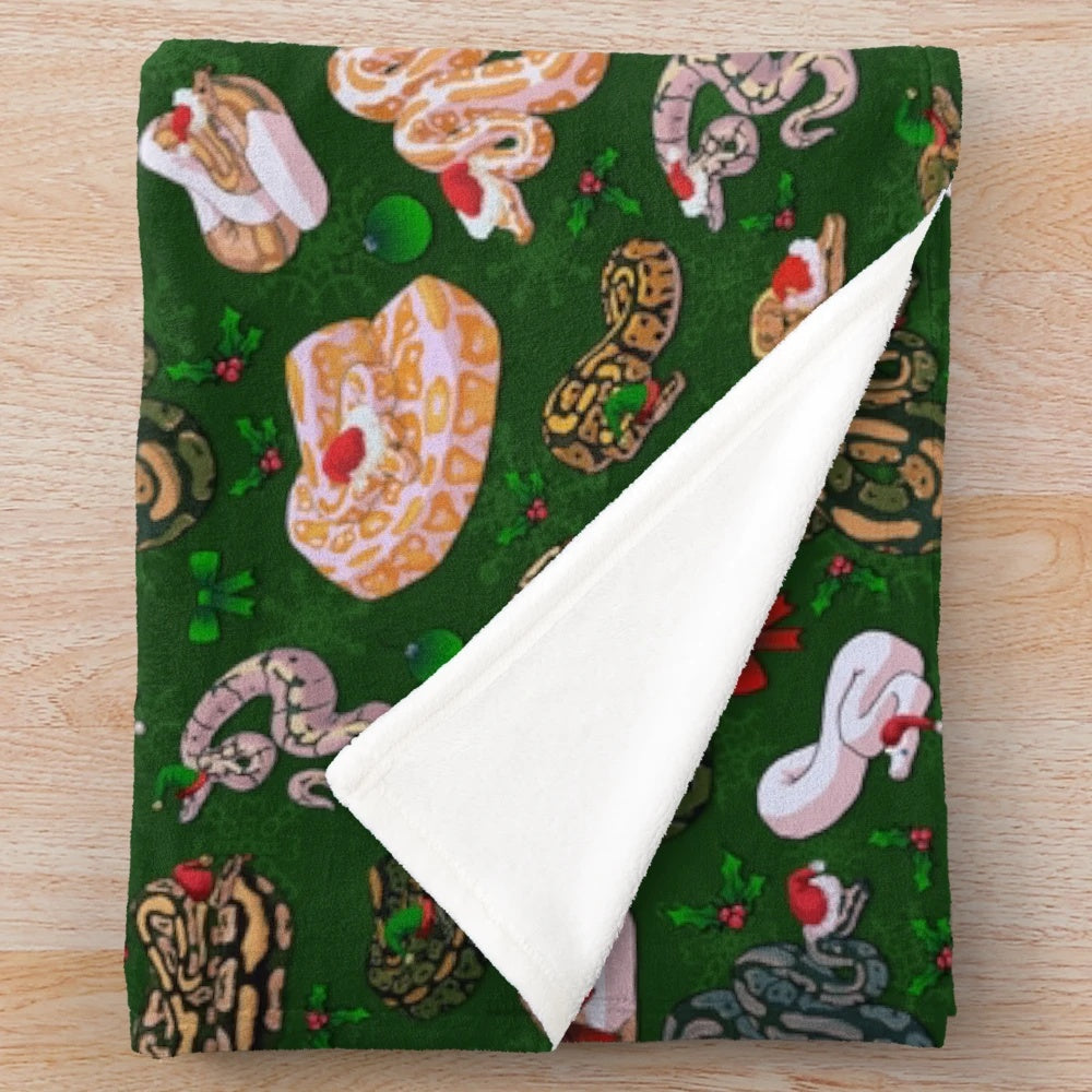 Cozy and soft plush blanket featuring a ball python in a holiday design
