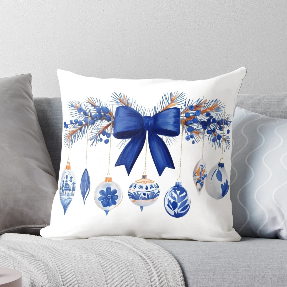 Blue and white chinoiserie-style Christmas pillow with pine branches, berries, and a bow