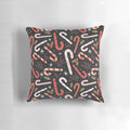 Vibrant candy cane-patterned Christmas pillow with holly and snowflake accents